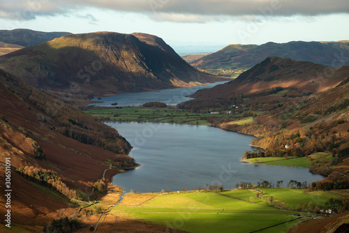 Majestic vibrant Autumn Fall landscape of Buttermere and Crummock Water flanked by mountain peaks of Haystacks High Stile and Mellbreak in Lake District