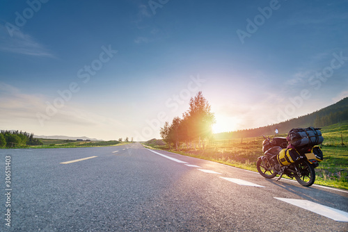 Fotografie Touring motorcycle with big baggage parking on asphalt roadside