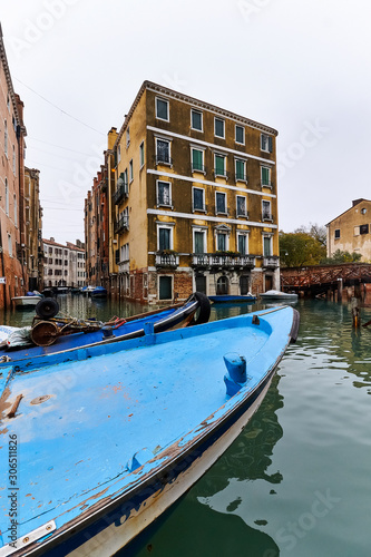 gondolas and boats ancored on a canal in venice