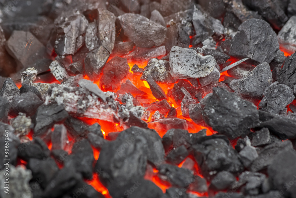Embers glow in a forge or bonfire. Fire, heat, coal and ash with flying sparks. Embers glow in a forge or bonfire. Fire, heat, coal and ash with flying sparks.