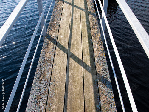 Wooden bridge with iron railings.