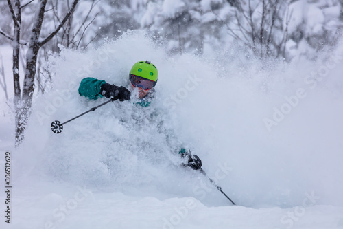 Freerider is buried in fresh snow, turning and jumping between the trees. freeride skiing in deep powder snow. Chest deep snow during snow storm. Good powder day. Funny skiing. Beautiful snowy forest