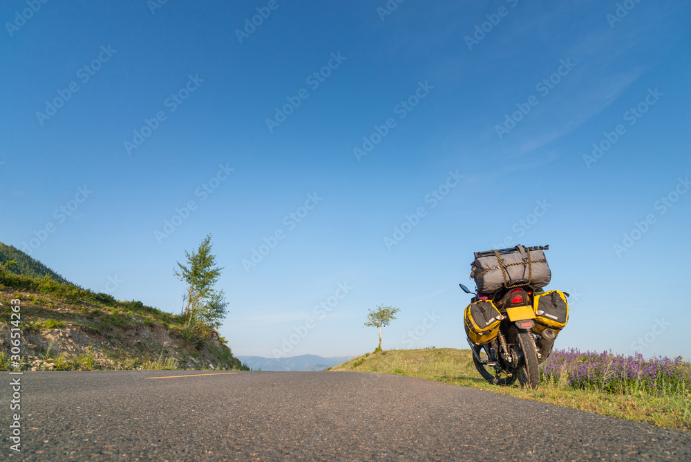 Motorcycle with baggage parking next to the roadside