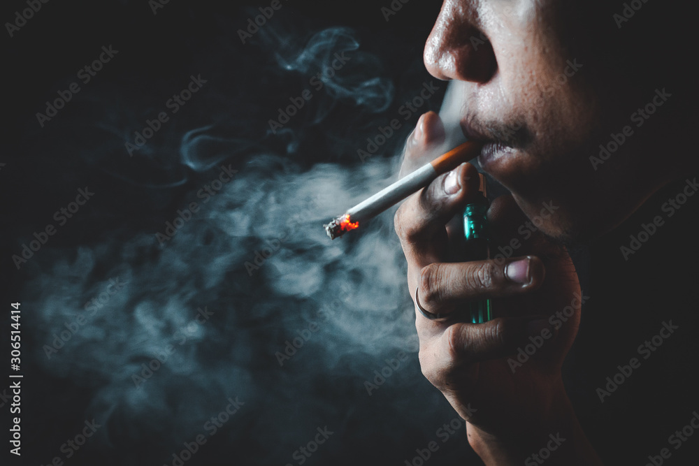Fototapeta premium People who smoke with a black background Causing lung cancer 