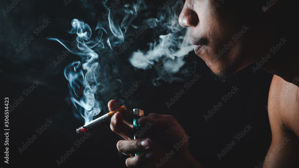 Fototapeta premium People who smoke with a black background Causing lung cancer 
