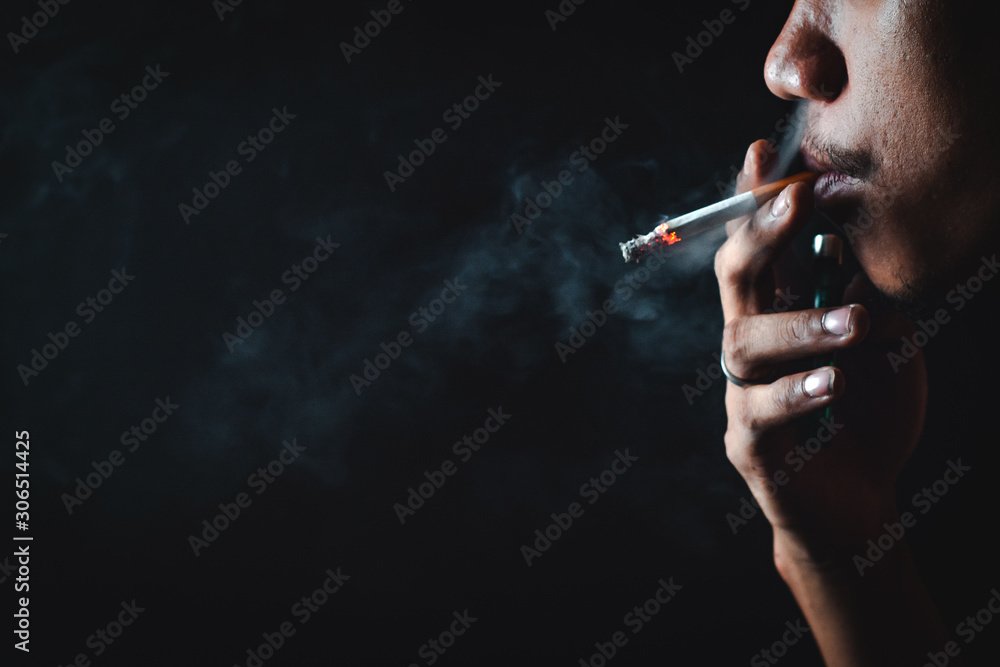 Fototapeta premium People who smoke with a black background Causing lung cancer 