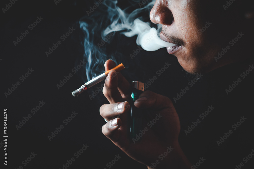 Fototapeta premium People who smoke with a black background Causing lung cancer 