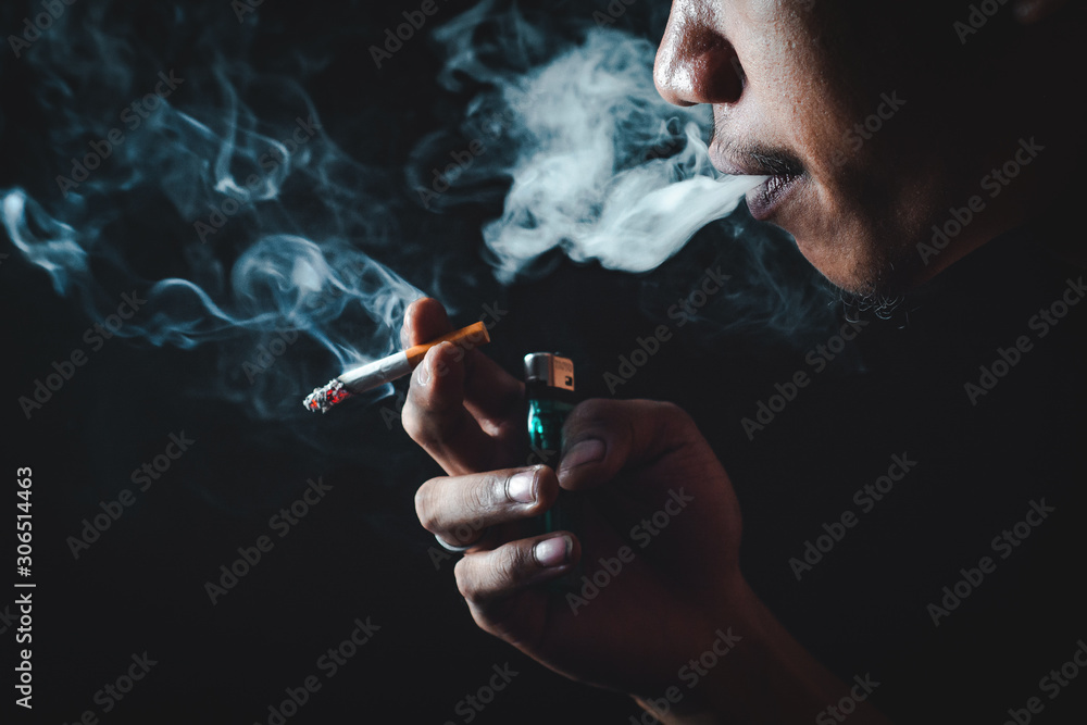 Fototapeta premium People who smoke with a black background Causing lung cancer 