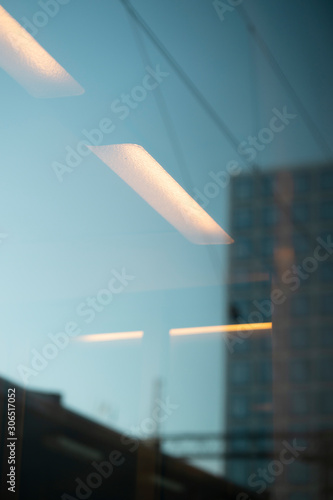 Lights reflecting off a window with an abstrtact city background