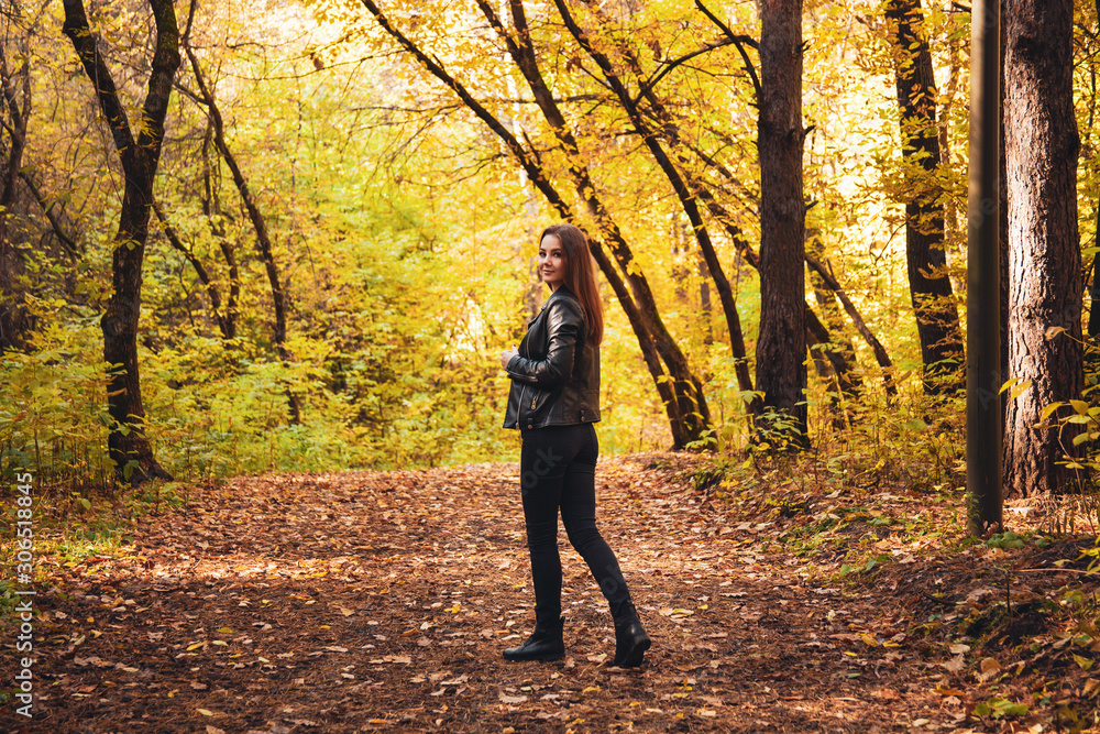 Young woman walks in the autumn forest. Young woman walks in the autumn forest.