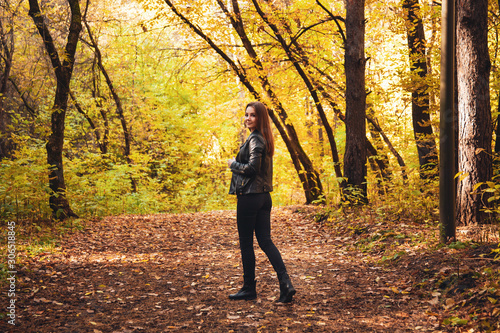 Young woman walks in the autumn forest. © Galaxy_love_design