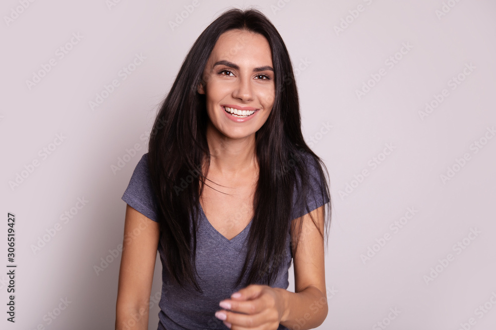 Self-expression. Close-up photo of a relaxed happy woman with sincere face expression, who is laughing with joy and looking in the camera. Self-expression. Close-up photo of a relaxed happy woman with sincere face expression, who is laughing with joy and looking in the camera.