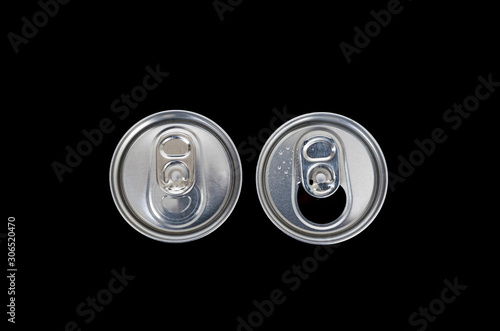  Top view of an unopened and opened metal can on dark background.