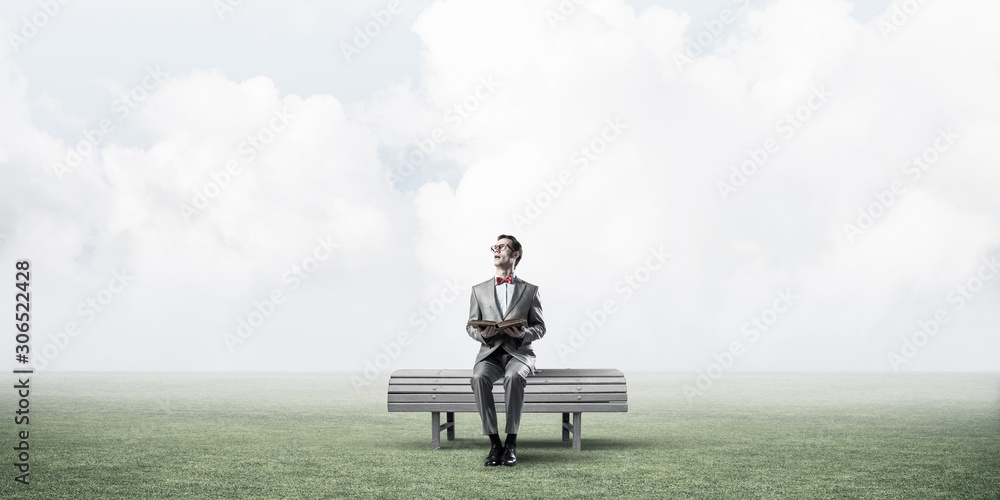 Young businessman or student studying the science in summer park Young businessman or student studying the science in summer park