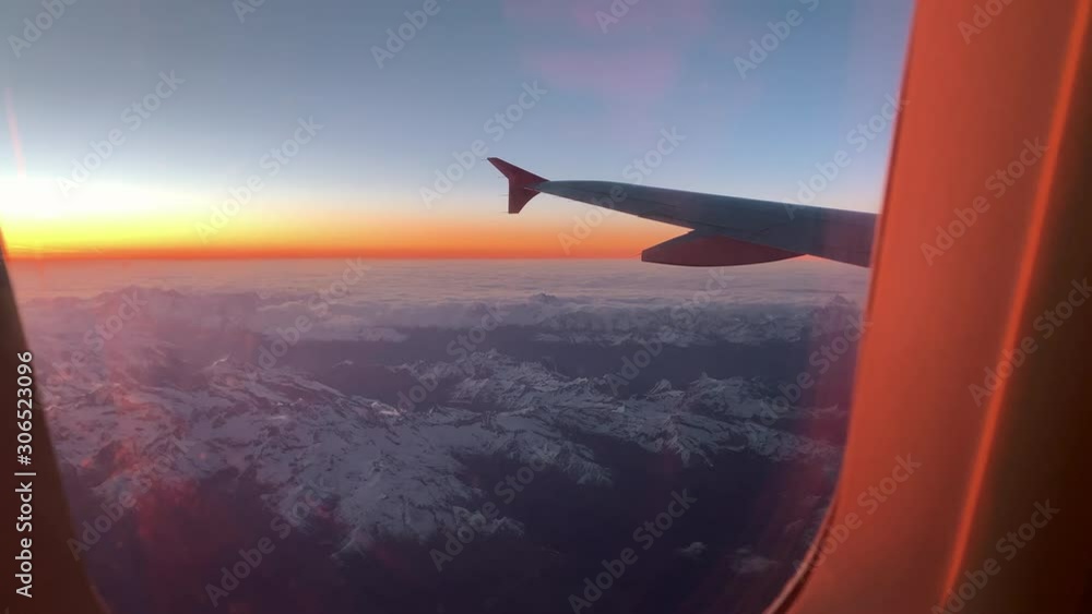 Flying over the Alps. View from the airplane porthole to the top of Mont Blanc Flying over the Alps. View from the airplane porthole to the top of Mont Blanc