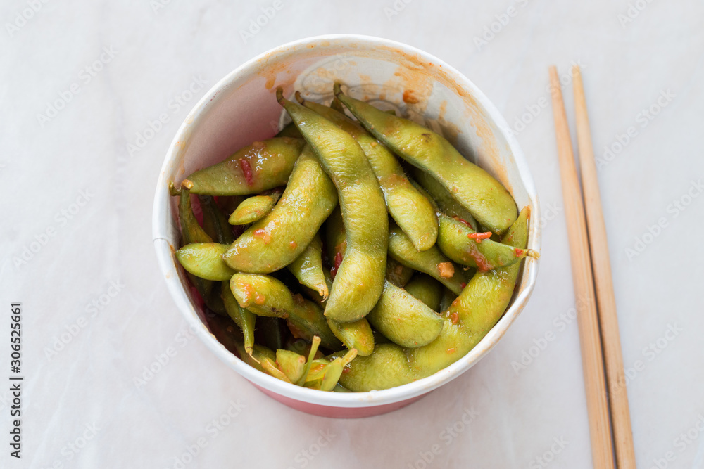 Healthy Take Away Asian Food Spicy Sambal Edamame with Chopsticks / Spiced Style with Red Hot Chili Sauce in Plastic Box Package / Container. Healthy Take Away Asian Food Spicy Sambal Edamame with Chopsticks / Spiced Style with Red Hot Chili Sauce in Plastic Box Package / Container.