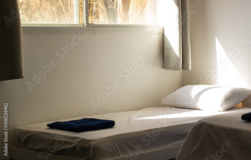 Photography poor interior in hostel cheap room bed white sheep in morning sun rise time