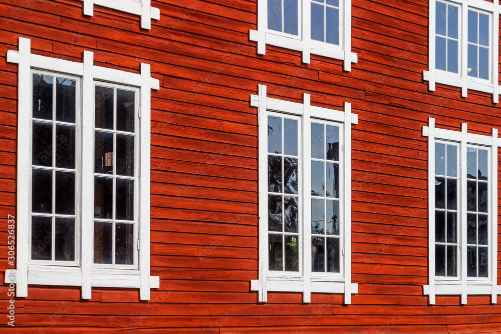 Beautiful old red wooden facade with windows Beautiful old red wooden facade with windows