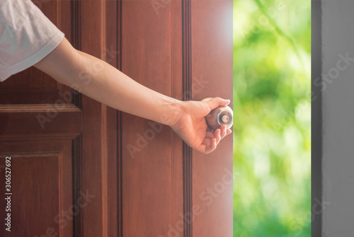 Women hand open door knob or opening the door. photo