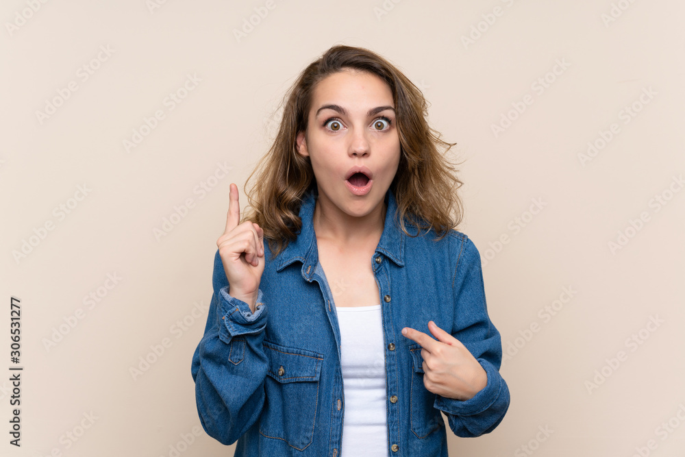 Young blonde woman over isolated background with surprise facial expression Young blonde woman over isolated background with surprise facial expression