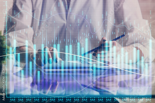 Financial forex graph drawn over hands taking notes background. Concept of research. Double exposure © peshkova