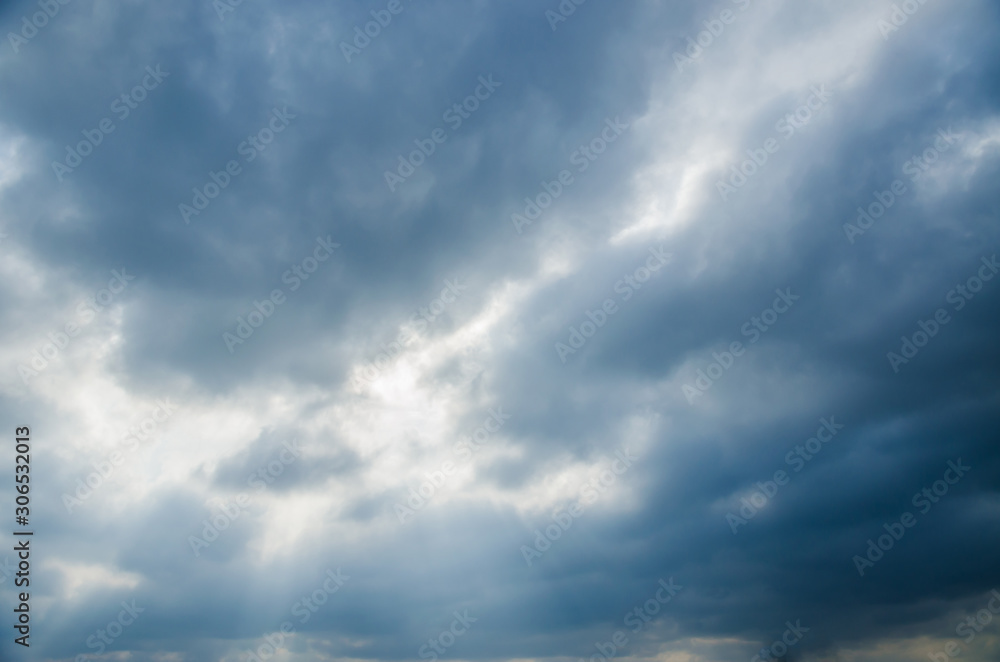 View of the sky. The sky is covered with clouds with glimmers of sunlight.