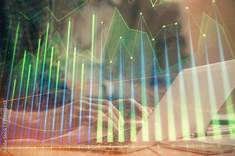 Double exposure of stock market chart with man working on computer on background. Concept of financial analysis. Double exposure of stock market chart with man working on computer on background. Concept of financial analysis.