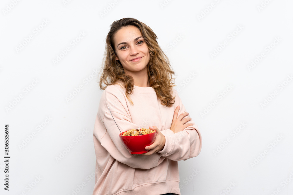 Young blonde woman holding a bowl of cereals Young blonde woman holding a bowl of cereals