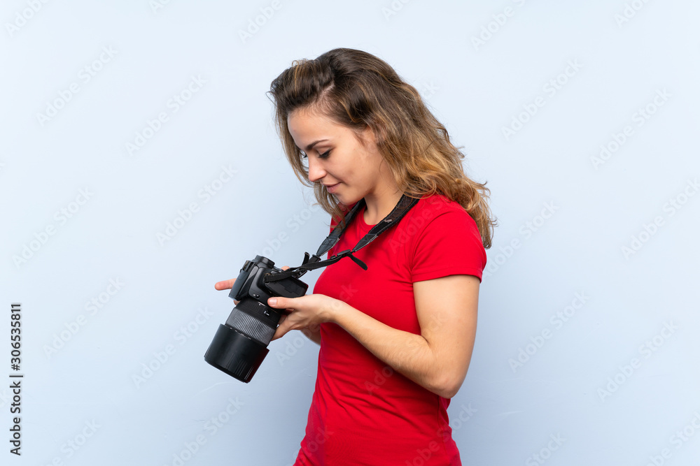 Young blonde woman with a professional camera Young blonde woman with a professional camera