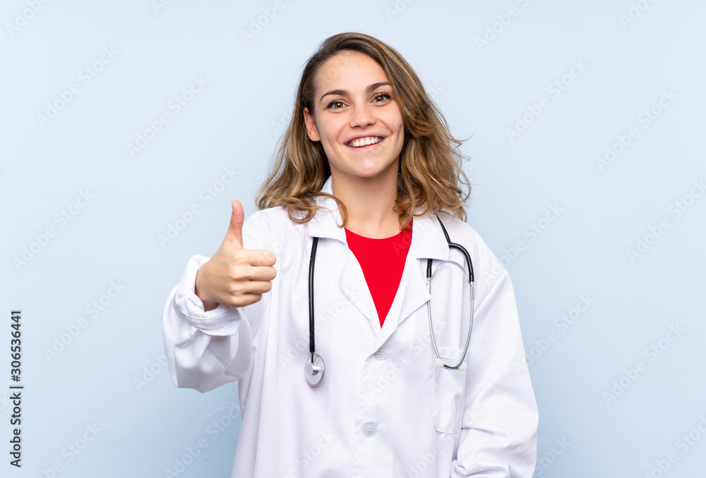 Young blonde woman with doctor gown and with thumb up