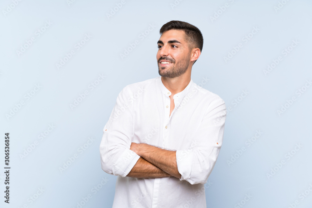 Handsome man with beard over isolated blue background happy and smiling Handsome man with beard over isolated blue background happy and smiling