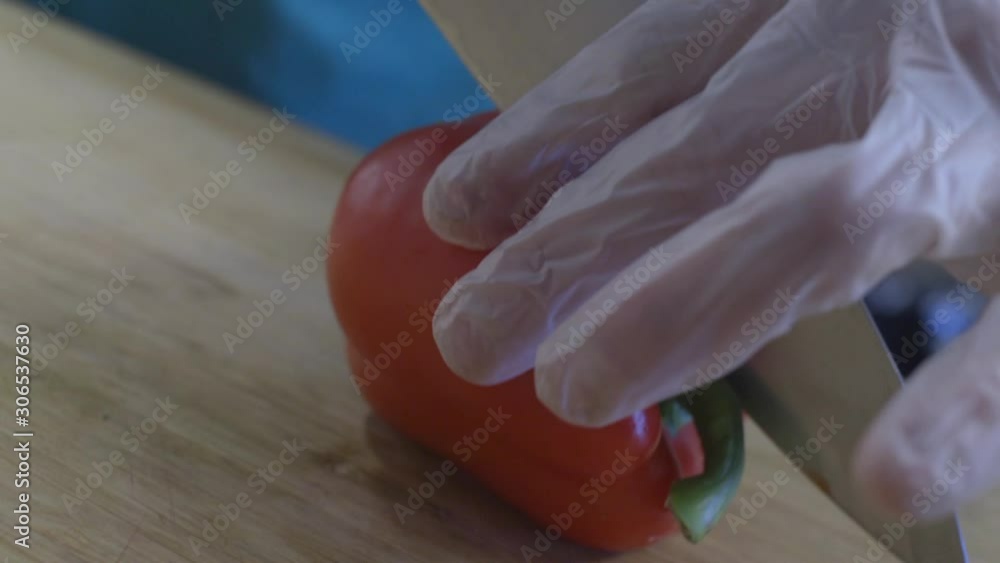 Paella event catering with a healthy choice chef is ready to go knife in hand cuts red pepper in slow motion Paella event catering with a healthy choice chef is ready to go knife in hand cuts red pepper in slow motion