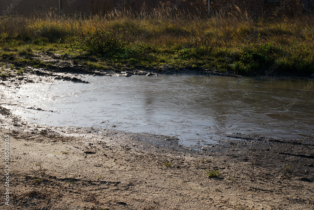 Puddles on wasteland on the outskirts of a small city in Poland Puddles on wasteland on the outskirts of a small city in Poland