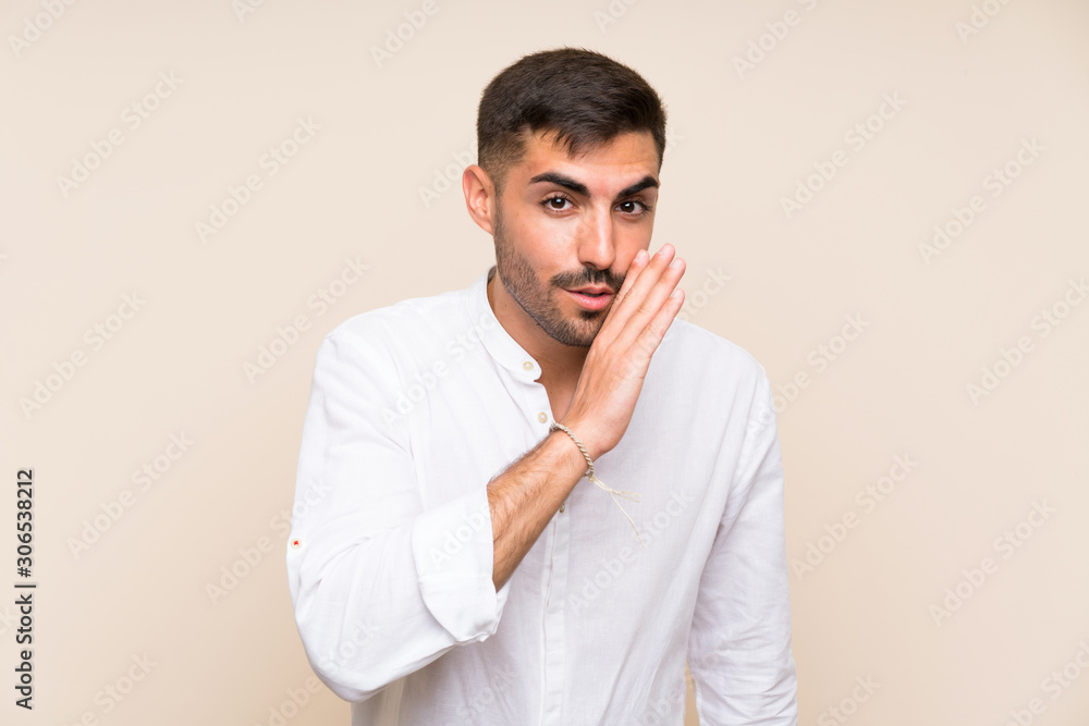 Handsome man with beard over isolated background whispering something Handsome man with beard over isolated background whispering something