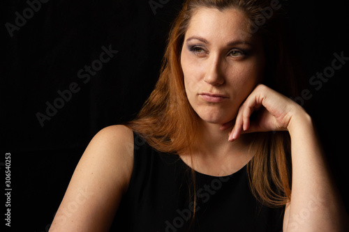 Sexy girl is vacuuming. Fatigue from cleaning and household chores. on a black background