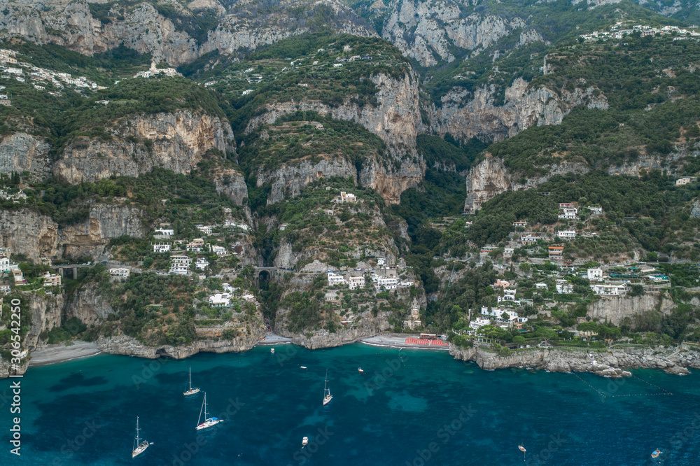 Aerial drone shot ivew of Amalfi coast road on mountain crags in the morning