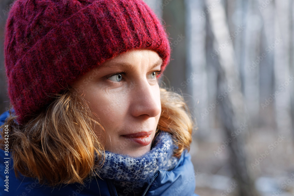 Closeup outdoor portrait of woman walking in the forest against blurred background Closeup outdoor portrait of woman walking in the forest against blurred background