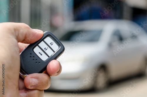 Fototapeta Naklejka Na Ścianę i Meble -  Car smart key is an electronic access and authorization system, Hand holding smart key of car.