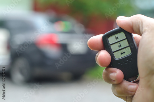 Fototapeta Naklejka Na Ścianę i Meble -  Car smart key is an electronic access and authorization system, Hand holding smart key of car.