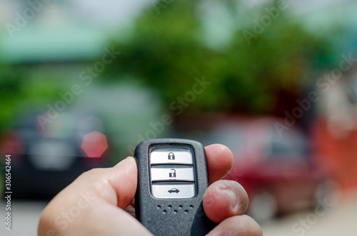 Car smart key is an electronic access and authorization system, Hand holding smart key of car. © Sawat