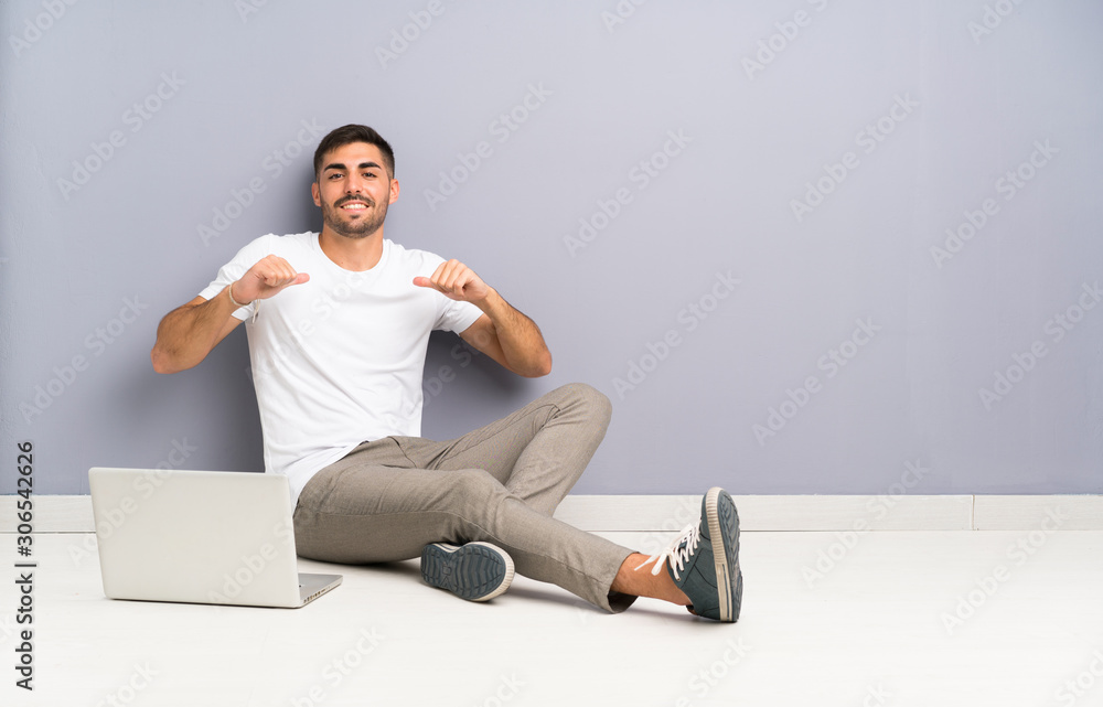 Young man with his laptop sitting one the floor proud and self-satisfied Young man with his laptop sitting one the floor proud and self-satisfied