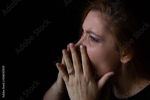 Wallpaper Mural portrait of a young beautiful woman who blows her nose on a black background. Torontodigital.ca