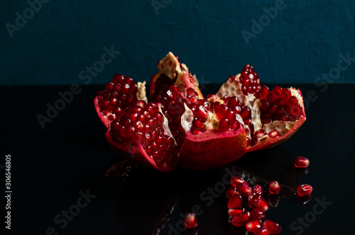Juicy ripe red grenades on a dark background. Organic and benefit garnet fruit.