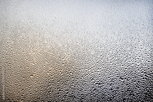 A foggy window close-up. Water droplets on a glass. Abstract background.