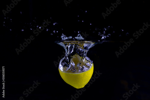 Lemon Slice in Water on Black Background, Lemon in Water on Black Background, Fruit in Water on Black Background, Lemon Slice, Yellow Lemon