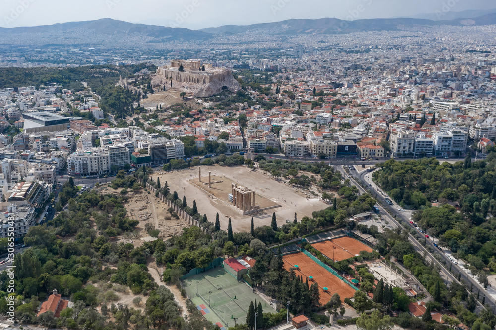 Aerial drone shot of Acropoli of Athens, museum and Zeus Olympion Temple collumn ruins