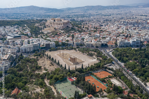 Aerial drone shot of Acropoli of Athens, museum and Zeus Olympion Temple collumn ruins