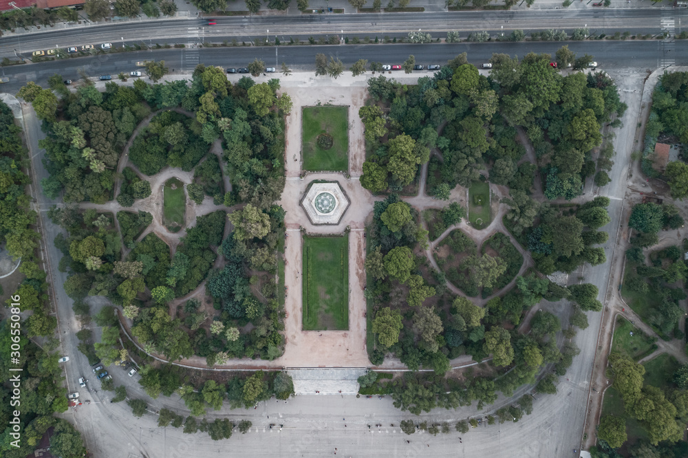 Aerial overhead drone shot of fountain in national garden in front of Zappeion Hall convention center in Athens