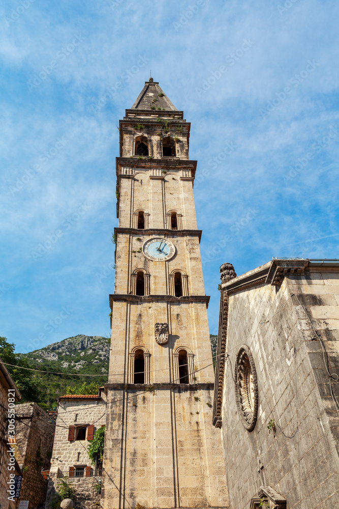 the ancient temple , the bell tower with a wall clock, Perast, Montenegro