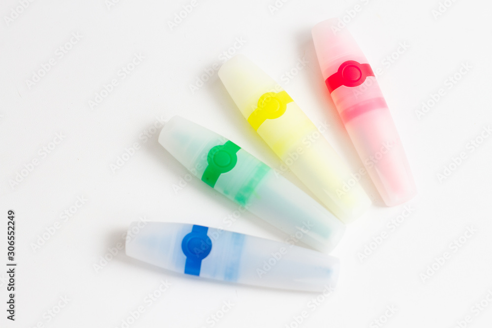 multi-colored felt-tip pens highlighters on a white background multi-colored felt-tip pens highlighters on a white background